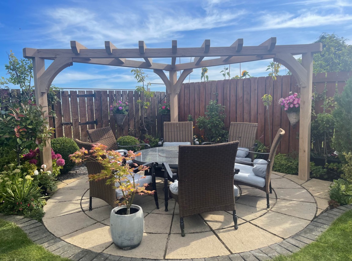 Patio furniture with a triangular pergola.